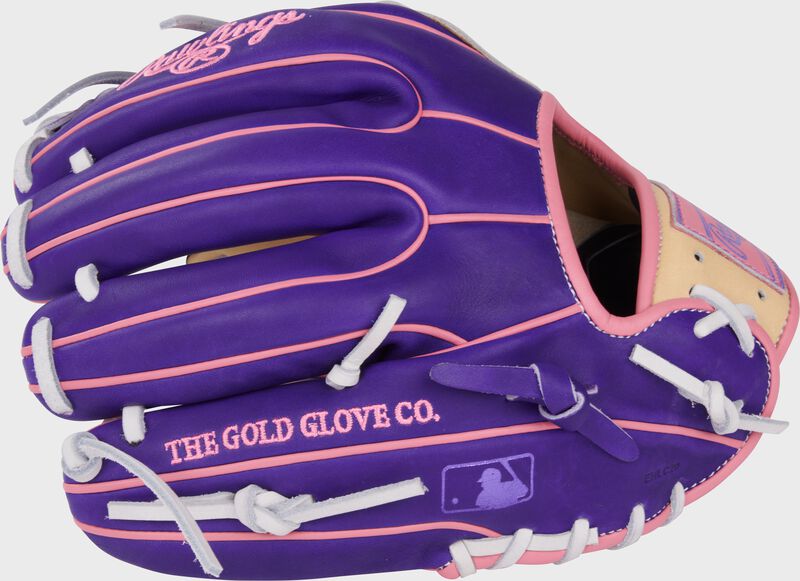 Purple back of a Heart of the Hide Vibrant Series camel/purple 11.5" infield glove with the MLB logo on the pinky