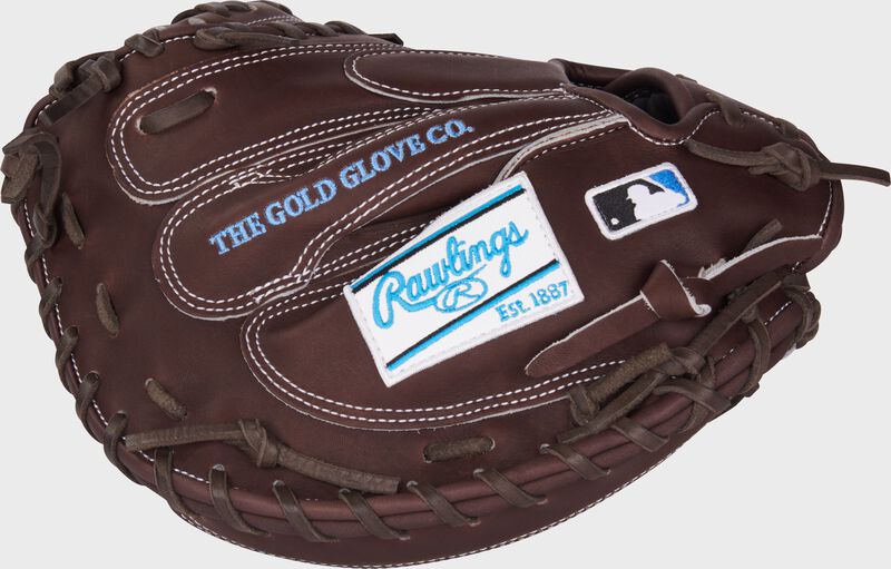 Chocolate back of a Heart of the Hide 33.5" cathcher's mitt with a white/Columbia blue Rawlings patch