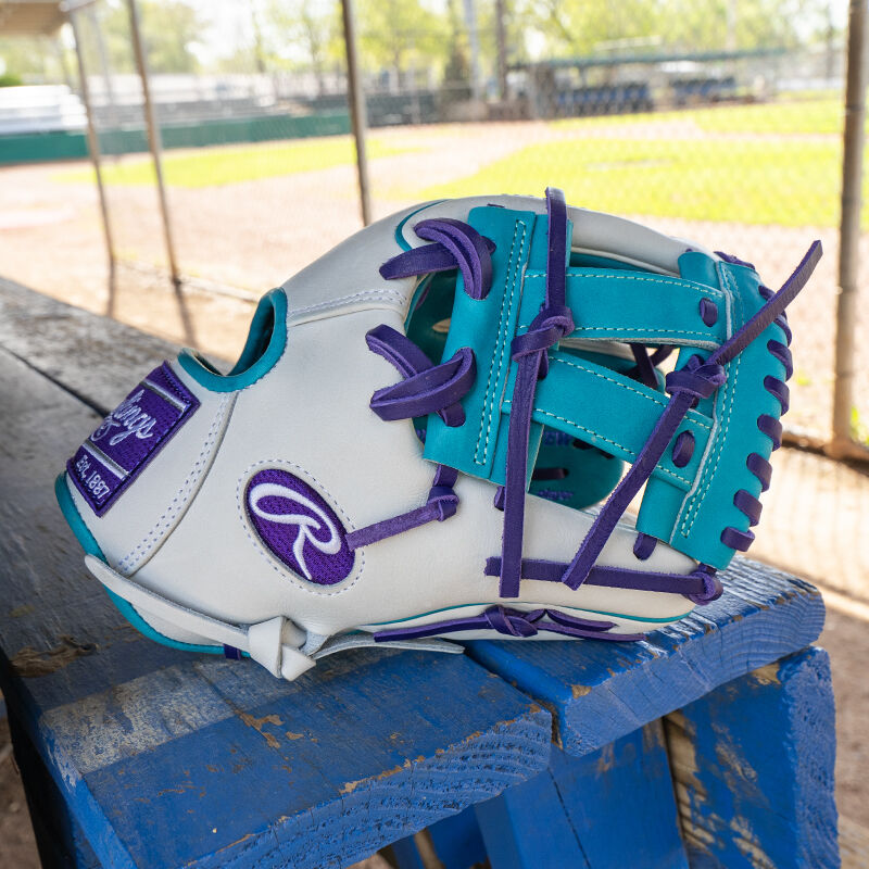 Picture of the thumb of a white/teal Rawlings exclusive Heart of the Hide R2G Wing Tip 11.5" infield glove on a table