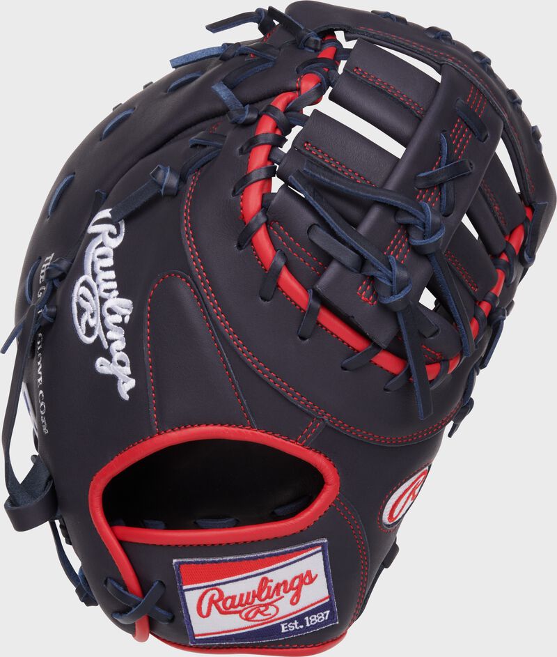 Navy back of a NXT Series 12.25" 1st base mitt with a red, white, & blue Rawlings patch