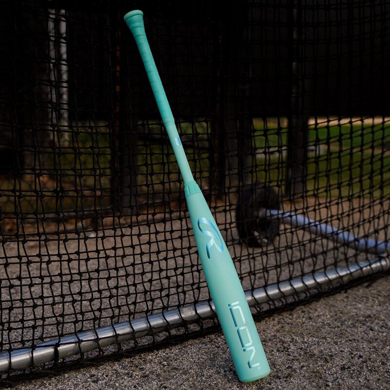 A 2026 Rawlings Icon BBCOR bat leaning against a batting cage loading=