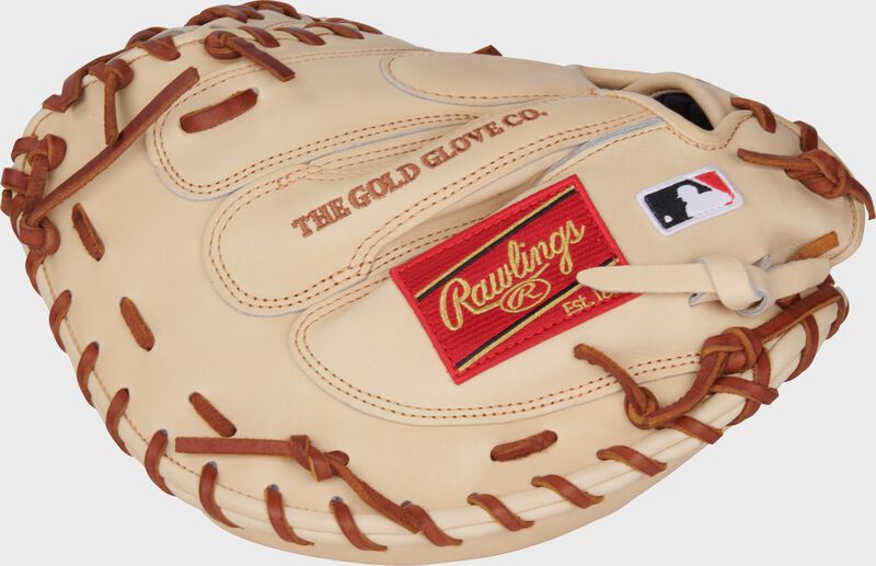 Back of a camel Heart of the Hide 34-Inch catcher's mitt with a red Rawlings patch and MLB logo on the pinky