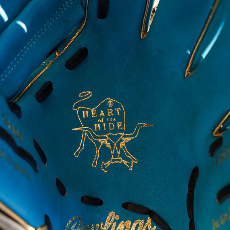 Picture of the gold Heart of the Hide stamp on the teal palm of an Exclusive 11.5" Rawlings R2G Heart of the Hide infield glove