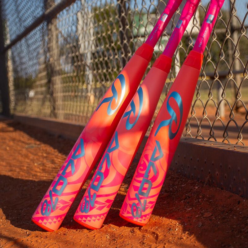 Picture of the barrels of three pink Rawlings ALO78 -12 fastpitch softball bats leaning against a fence