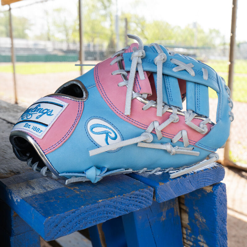Picture of the thumb of a Columbia blue/pink Exclusive Heart of the Hide 13-Inch 1st Base Mitt on a table