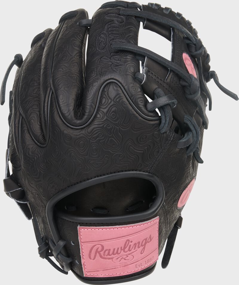 Black Wing Tip back of a Rawlings Heart of the Hide 11.5-Inch Wing Tip infield glove with a pink Rawlings patch