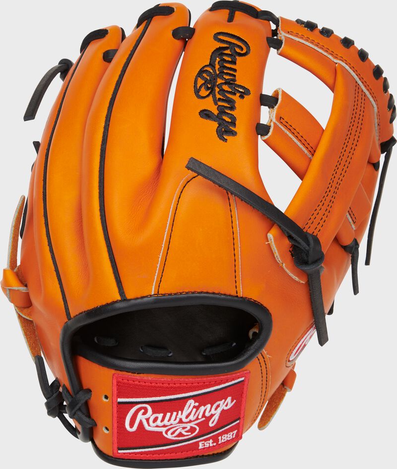 Back of an orange Jackson Holliday Heart of the Hide Infield Glove with a red Rawlings patch