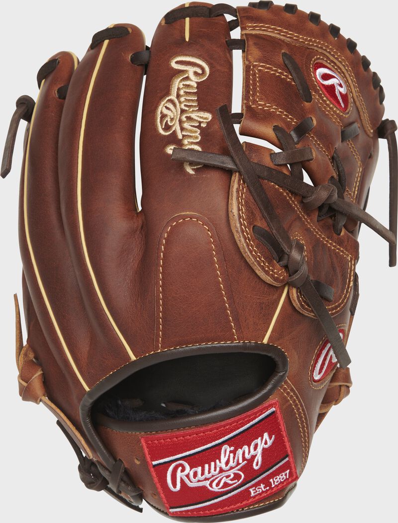 Chocolate back of a 12" Rawlings Heritage Pro 2-Piece solid web glove with a red Rawlings patch - SKU: HP206-9CCH loading=