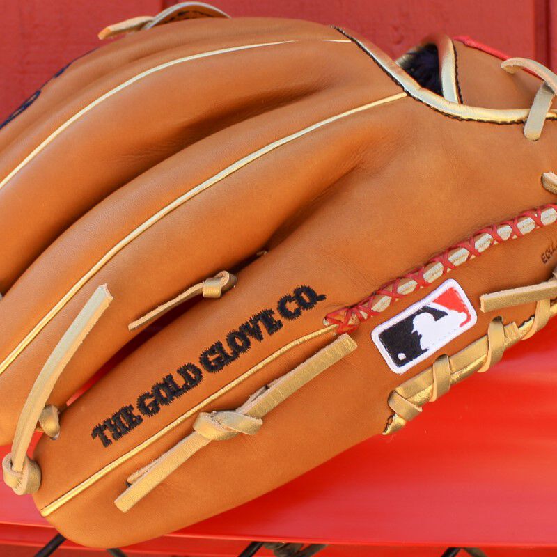 Hand-sewn welting and MLB logo on the pinky of a Sierra Romero glove on top of a fence - SKU: PROSR32
