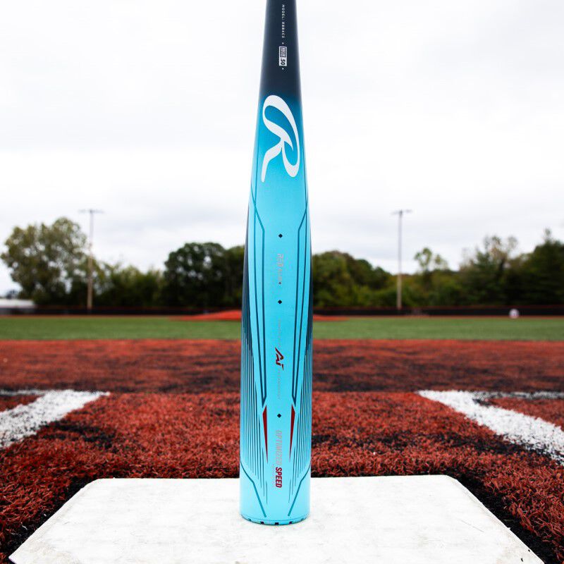 A light blue Clout AI -3 BBCOR bat standing up on its end on top of home plate
