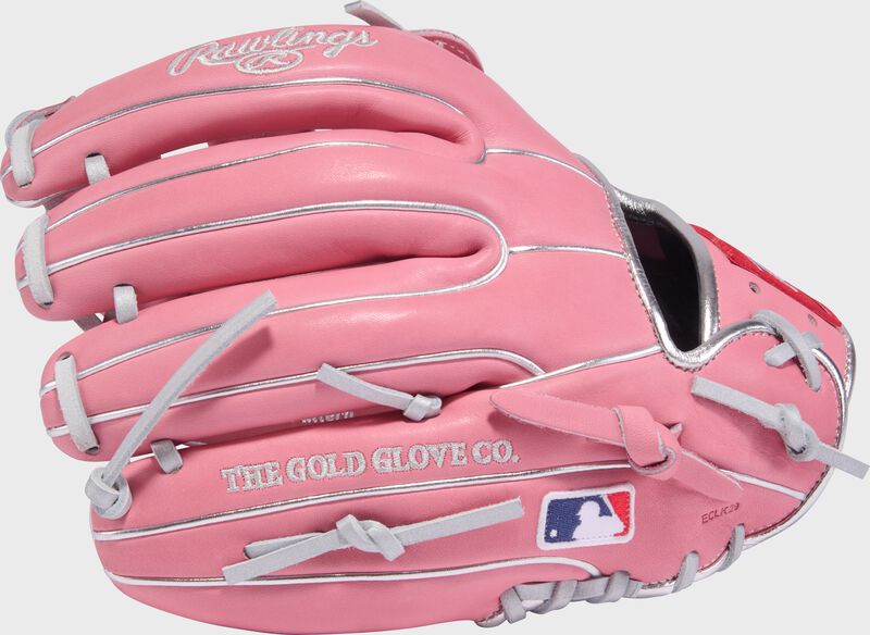 Back of a pink Gameday 57 Series Carlos Correa Heart of the Hide glove with the MLB logo on the pinky