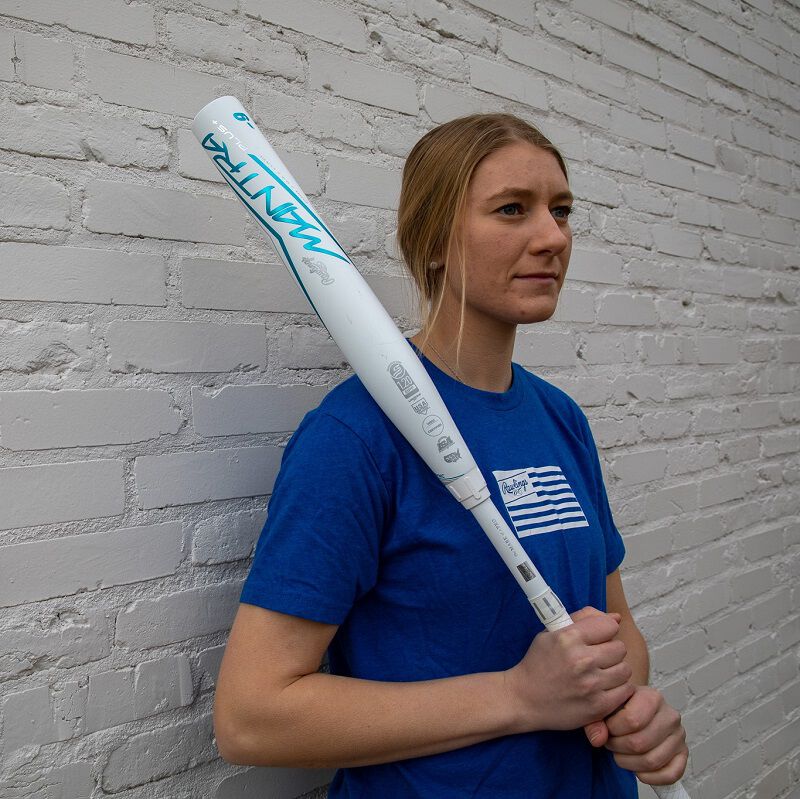 A player standing in front of a white wall holding a Rawlings Mantra+ softball bat - SKU: RFP3MP