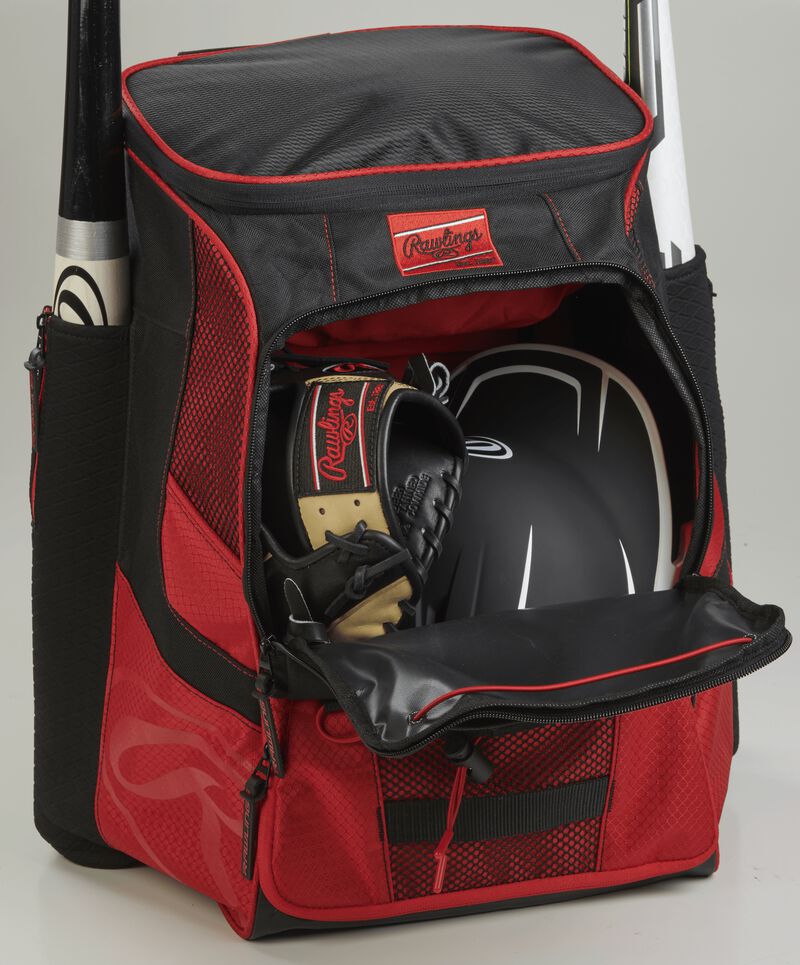 The main compartment of a scarlet/black R600 players team equipment backpack with a glove and helmet