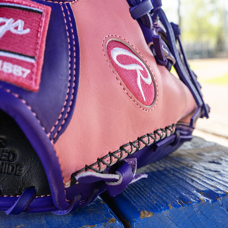 Picture of the hand-sewn welting on the thumb of a Rawlings exclusive 11.5" R2G Heart of the Hide pink/purple infield glove
