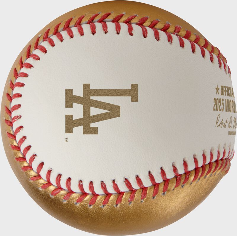 A gold Los Angeles Dodgers logo stamped on the white side of a MLB 2025 Gold World Series dueling baseball