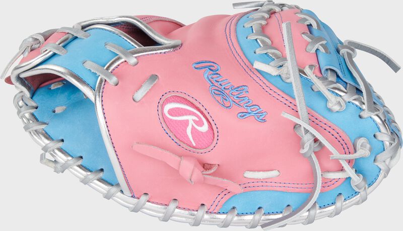 Thumb of a pink/Columbia blue exclusive Heart of the Hide 32.5" catcher's mitt with a pink Oval-R