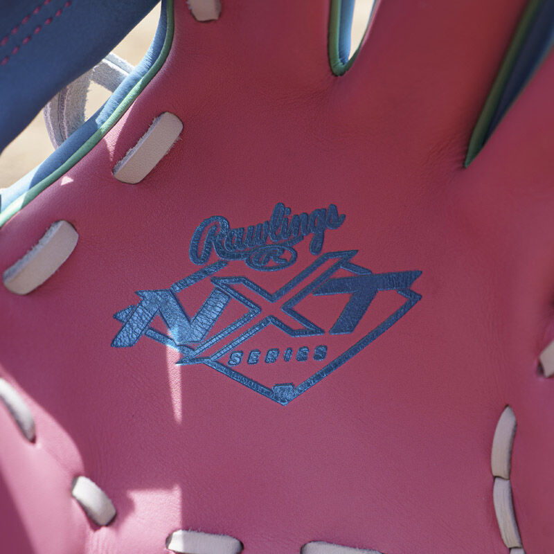 Columbia blue Rawlings NXT series logo stamped on the pink leather palm of an Exclusive Rawlings NXT Series 11.5" Infield Glove loading=