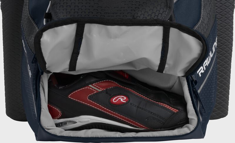 A navy Rawlings baseball backpack with a cleat in the bottom cleat storage compartment - SKU: IMPLSE-N