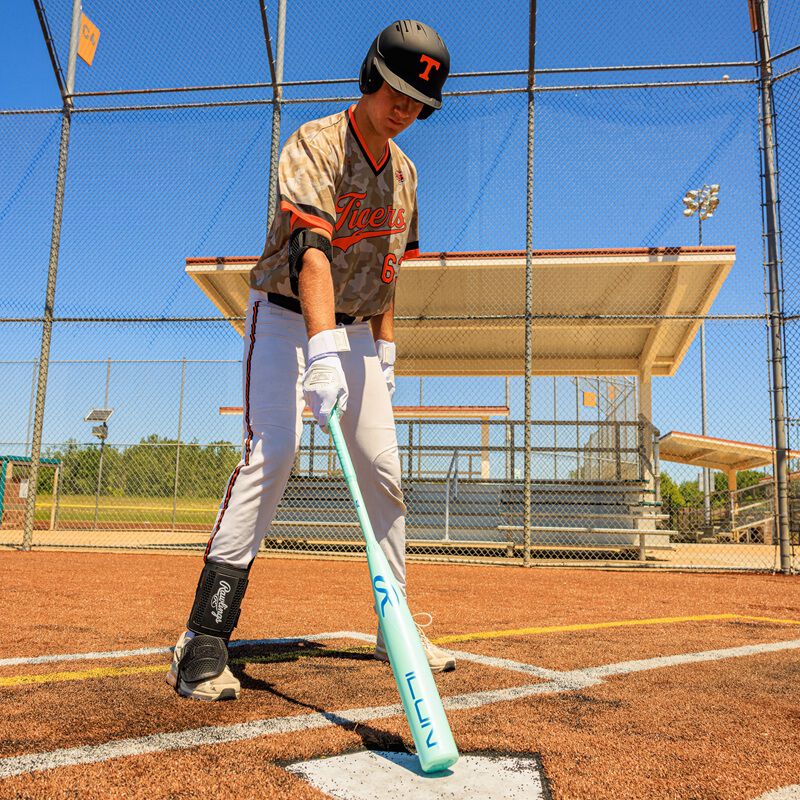 Picture of a player tapping home plate with a 2026 Rawlings Icon BBCOR bat loading=