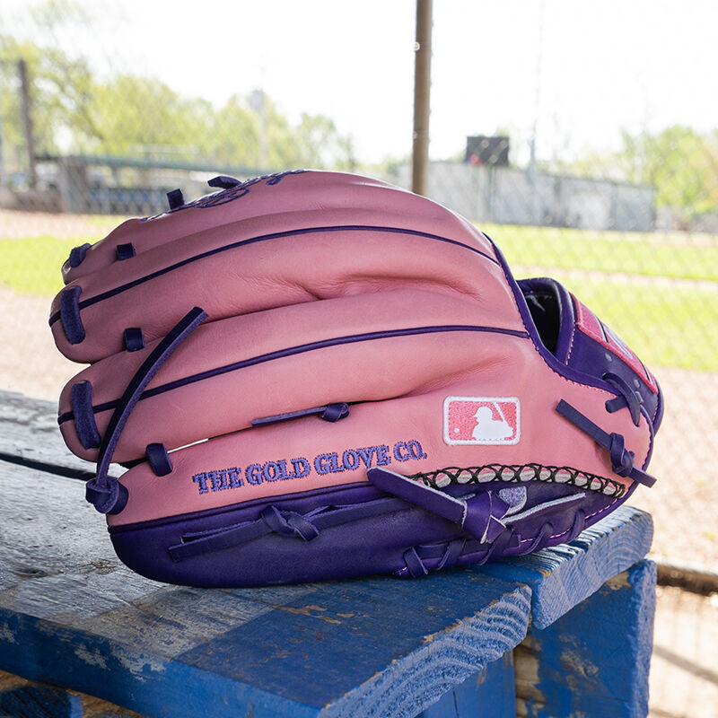 Picture of the back of a Rawlings exclusive 11.5" R2G Heart of the Hide pink/purple infield glove on a table