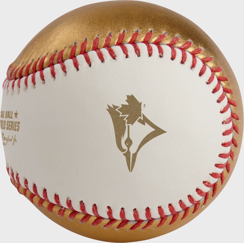 A gold Toronto Blue Jays logo stamped on the white side of a MLB 2025 Gold World Series dueling baseball