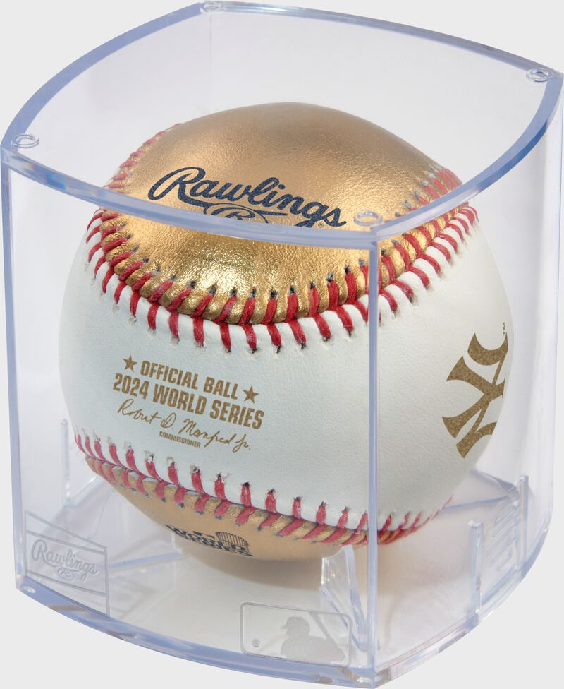 A MLB 2024 Gold World Series dueling baseball in a clear display cube