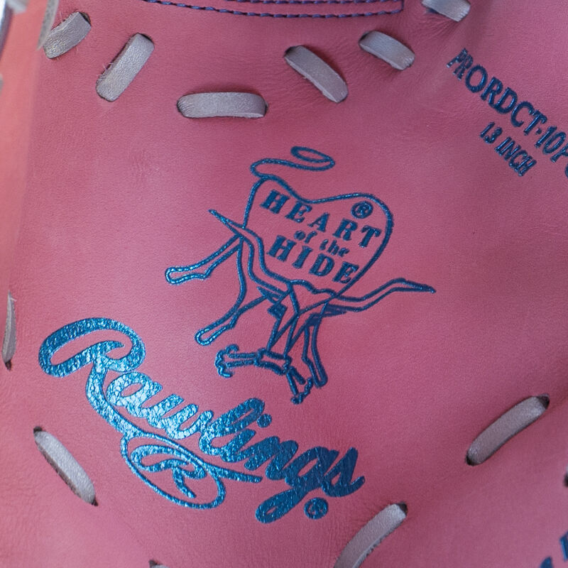 Picture of a columbia blue stamped Heart of the Hide logo on the pink leather palm of an Exclusive Heart of the Hide 13-Inch 1st Base Mitt
