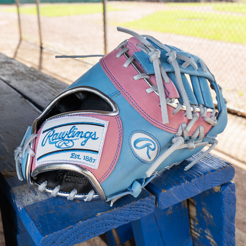 Picture of a columbia blue/pink Exclusive Heart of the Hide 13-Inch 1st Base Mitt on a table