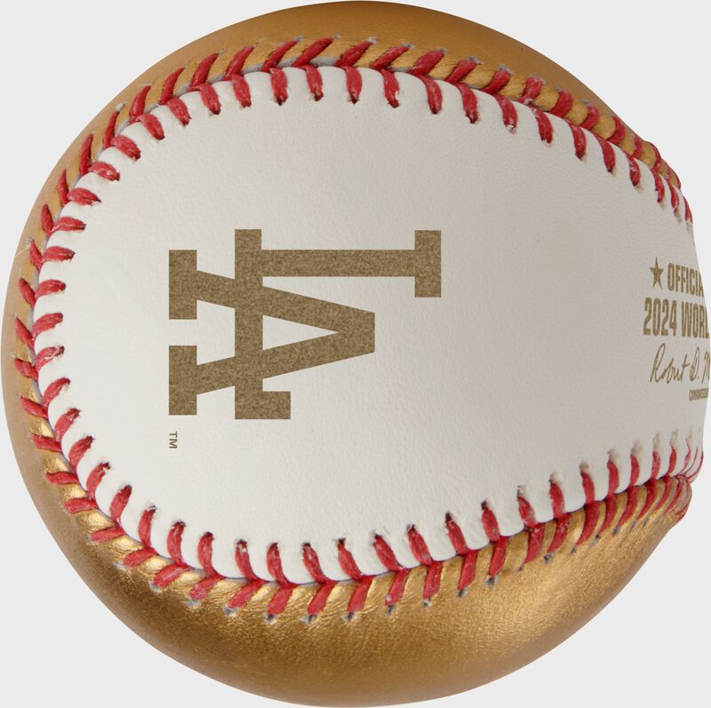 A gold Los Angeles Dodgers logo stamped on a white side of a Rawlings MLB 2024 World Series dueling baseball