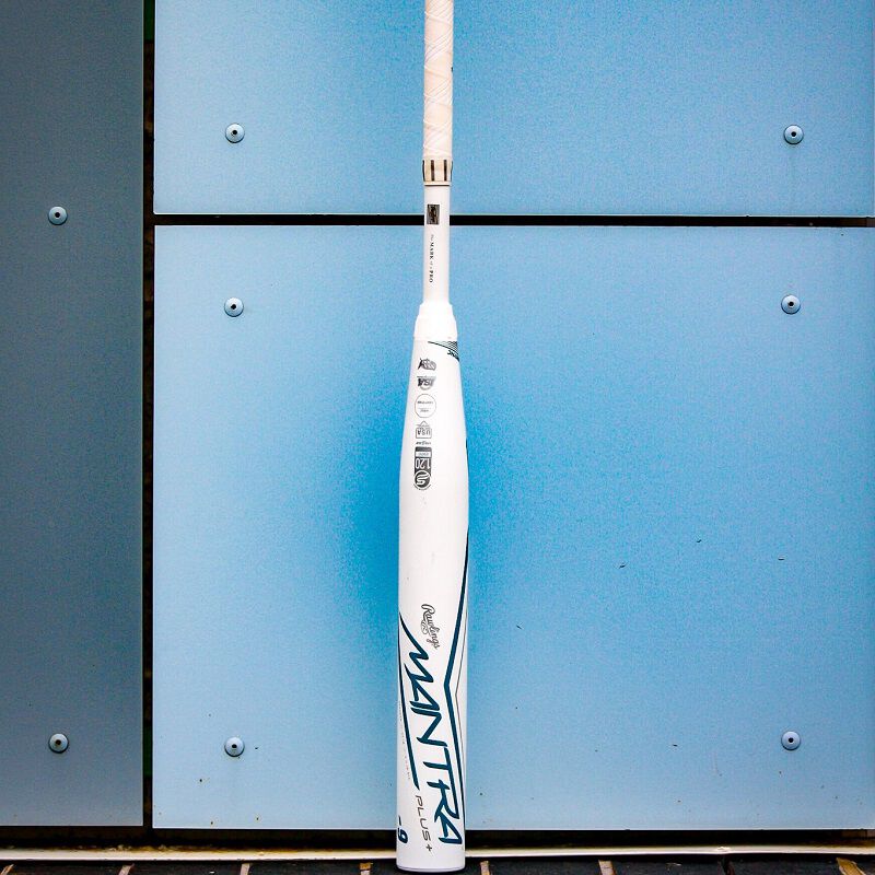 A white 2023 Rawlings Mantra+ fastpitch bat leaning against a wall - SKU: RFP3MP loading=