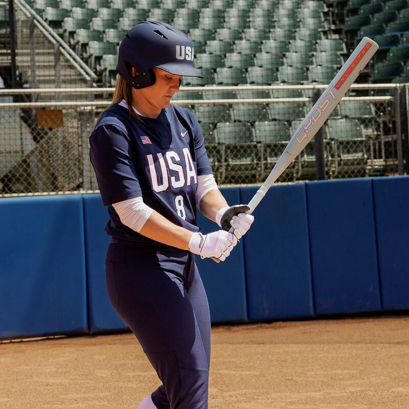 A picture of Haylie McCleney walking up to the plate with a 2025 Ghost Unlimited fastpitch bat