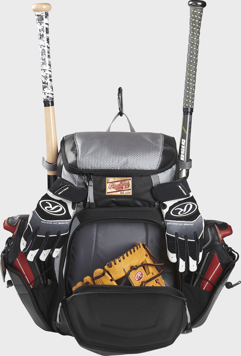 Front compartment of a black/gray R1000 Rawlings Gold Glove Series backpack with a glove and batting gloves