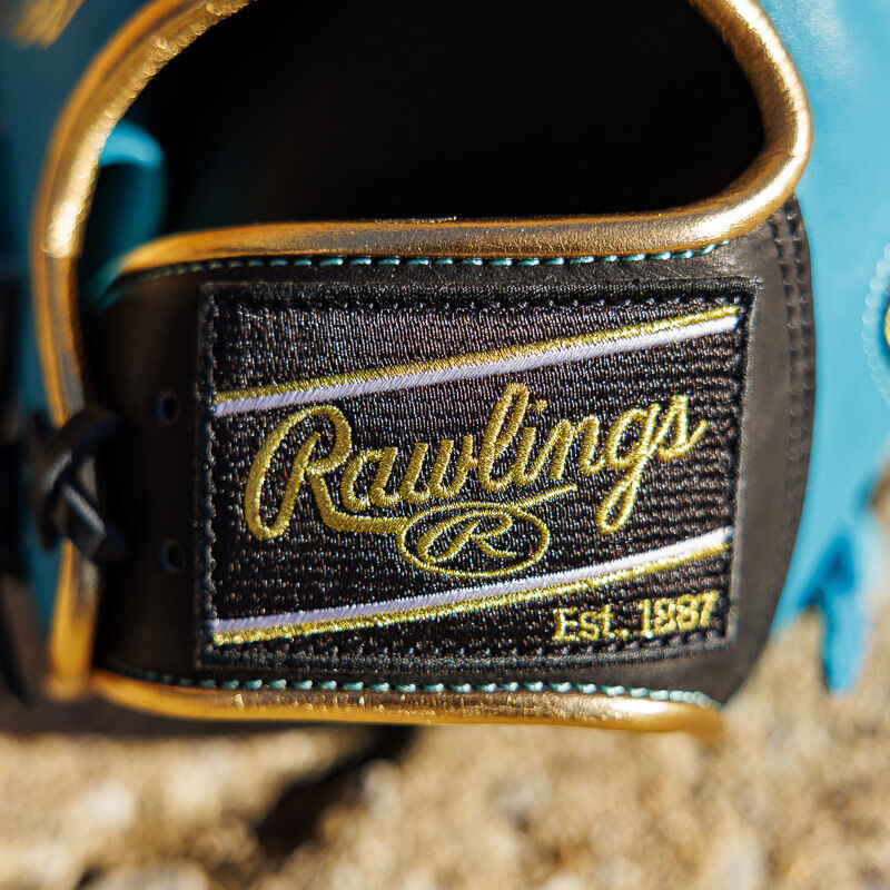 Picture of the black/gold Rawlings patch on a teal Exclusive 11.5" Rawlings R2G Heart of the Hide infield glove 