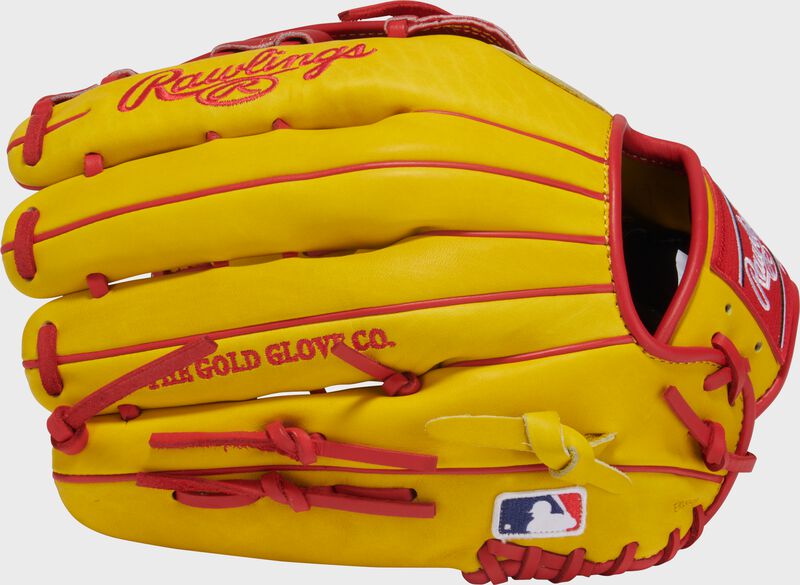 Back of a yellow Ronald Acuna Jr. Heart of the Hide glove with the MLB logo on the pinky