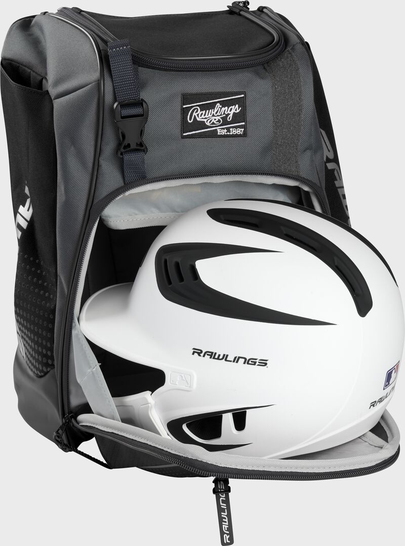 A white/black helmet in the main compartment of a black Rawlings Franchise backpack - SKU: FRANBP-B