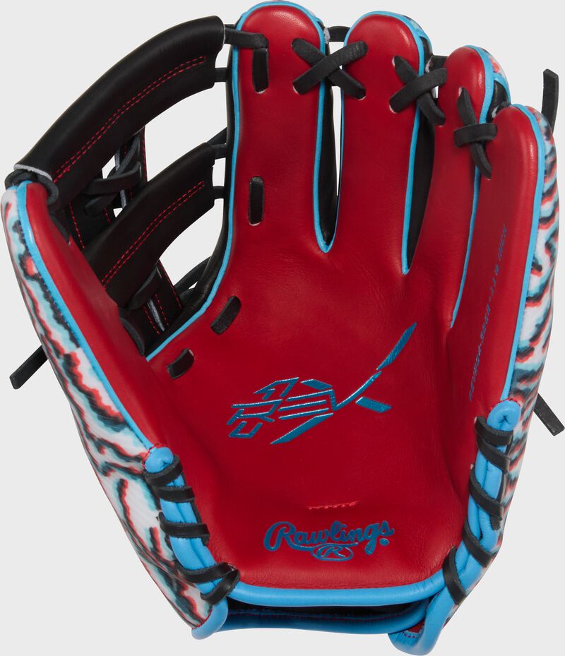 Scarlet leather palm of a Rawlings REV1X 11.5-Inch Infield Glove with Columbia blue stamping and black laces