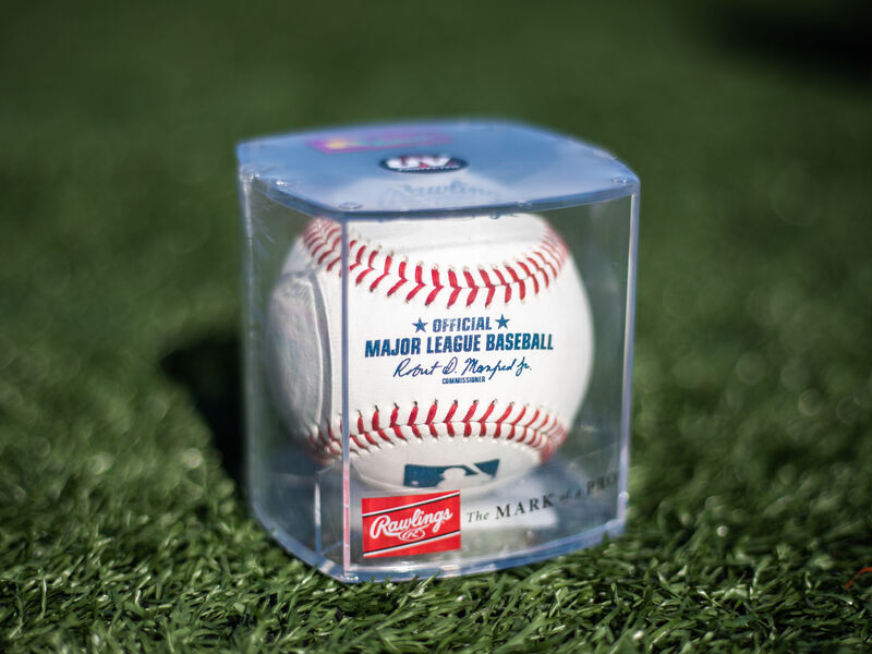 Official Major League baseball in a display cube sitting on a field - SKU: ROMLB-R loading=