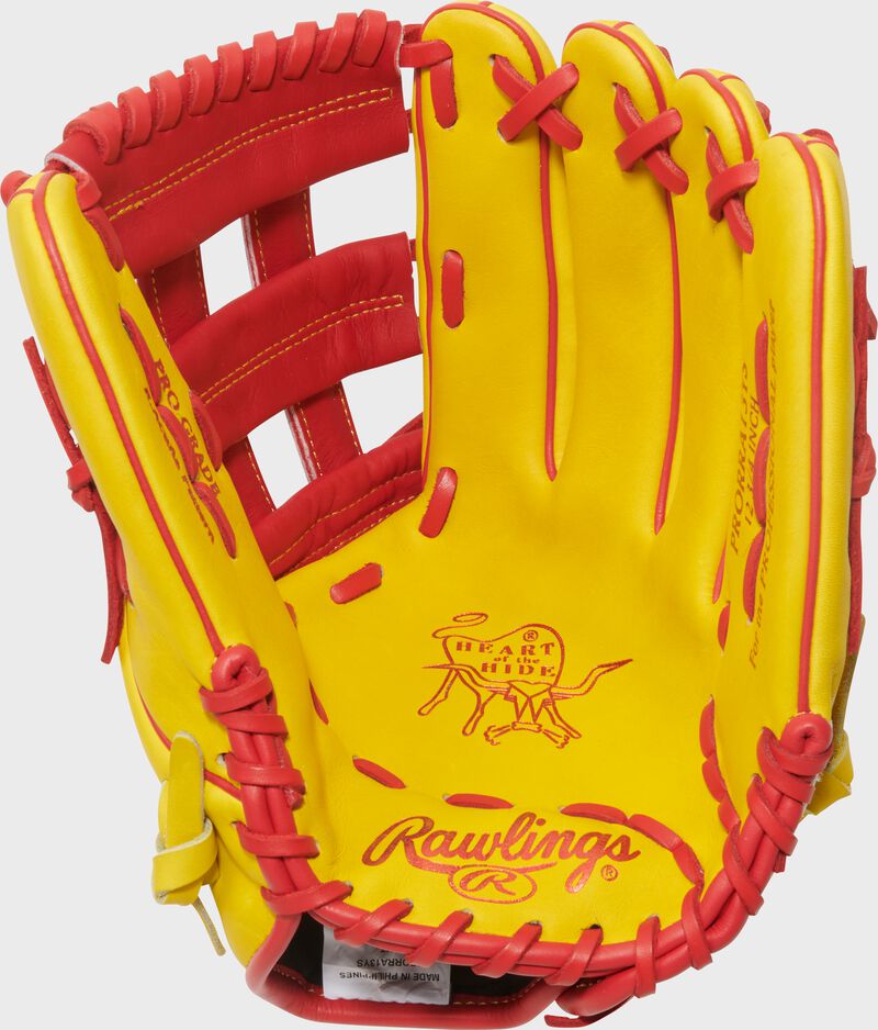 Yellow palm of a Rawlings Ronald Acuna Jr. Heart of the Hide glove with scarlet stamping and laces
