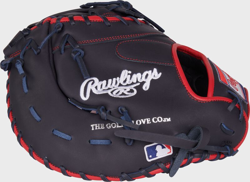 Navy back of a NXT Series 12.25" 1st base mitt with the MLB logo on the pinky