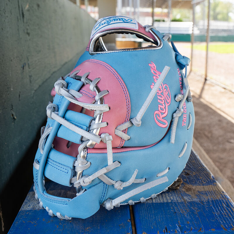 Picture of the back of an Exclusive Heart of the Hide 13-Inch 1st Base Mitt standing on its fingertips on a table