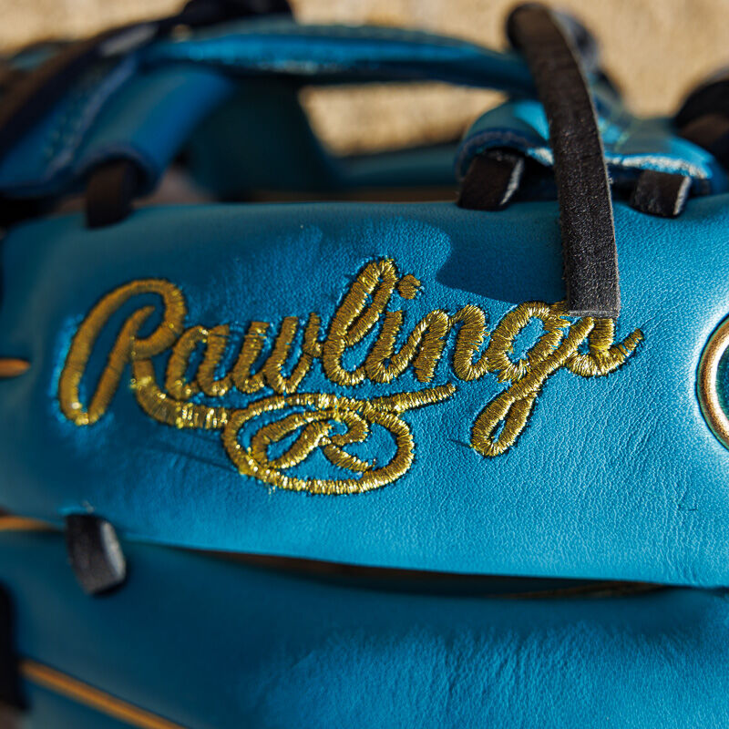 Gold Rawlings logo embroidered on the finger of a teal Exclusive 11.5" Rawlings R2G Heart of the Hide infield glove