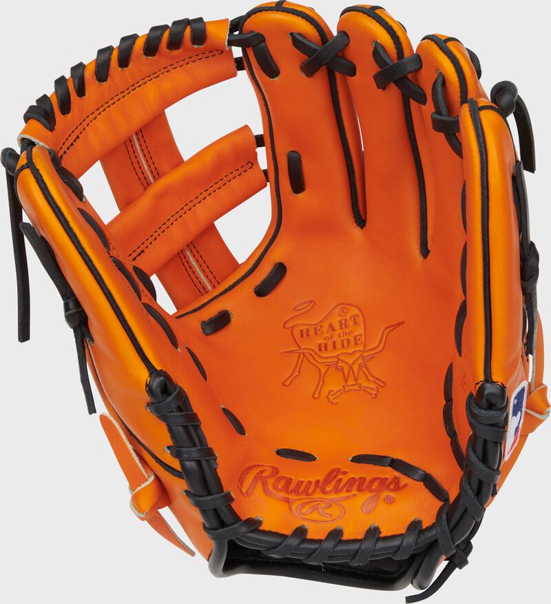 Palm of an orange Rawlings Jackson Holliday Heart of the Hide Infield Glove with black laces