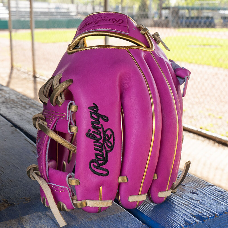 Picture of an Exclusive 11.5" R2G Heart of the Hide Berry infield glove on a table standing on its fingertips