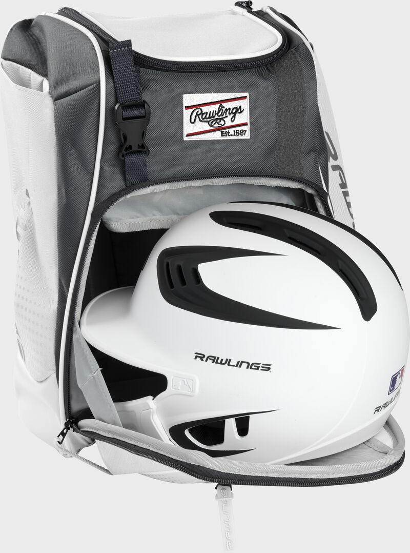A white/black helmet in the main compartment of a white Rawlings Franchise backpack - SKU: FRANBP-W