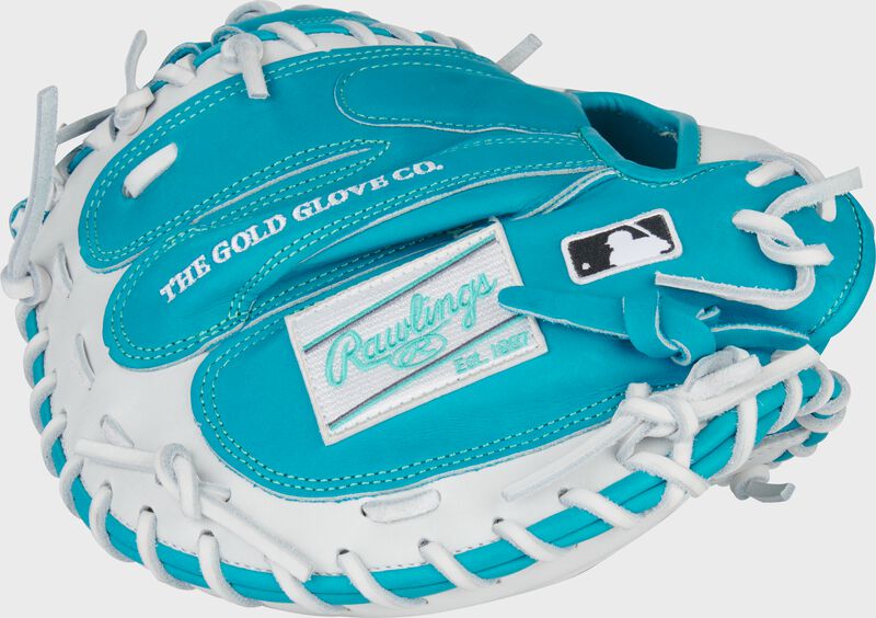 Back of a teal/white Exclusive Heart of the Hide 33-Inch Catcher's Mitt with a white Rawlings patch and MLB logo on the pinky
