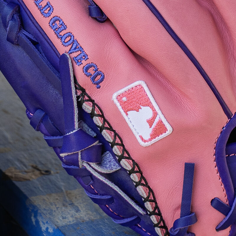 Picture of the hand-sewn welting and MLB logo on the pinky of a Rawlings exclusive 11.5" R2G Heart of the Hide pink/purple infield glove