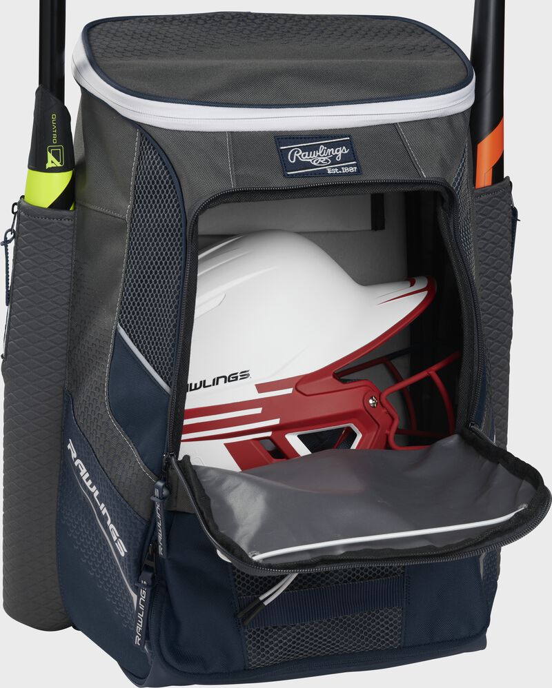 A navy Impulse baseball backpack with a helmet in the main compartment - SKU: IMPLSE-N