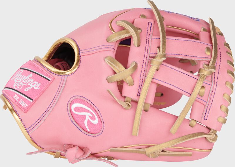 Thumb of a pink exclusive Heart of the Hide Wing Tip infield glove with a pink Pro V Web