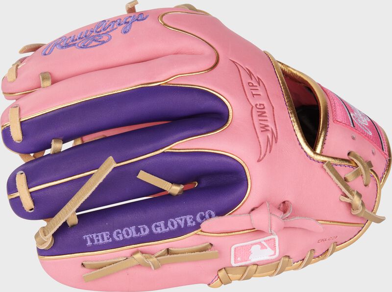Pink/purple Wing Tip back of a Heart of the Hide Wing Tip infield glove with the MLB logo on the pinky