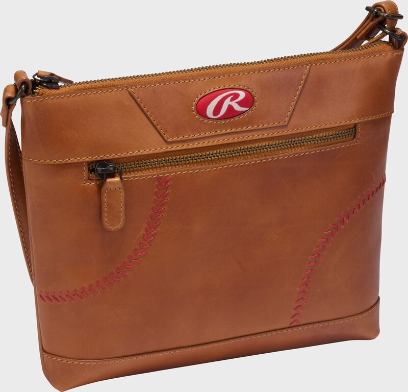 Side angle view of a tan Rawlings Double Play crossbody purse